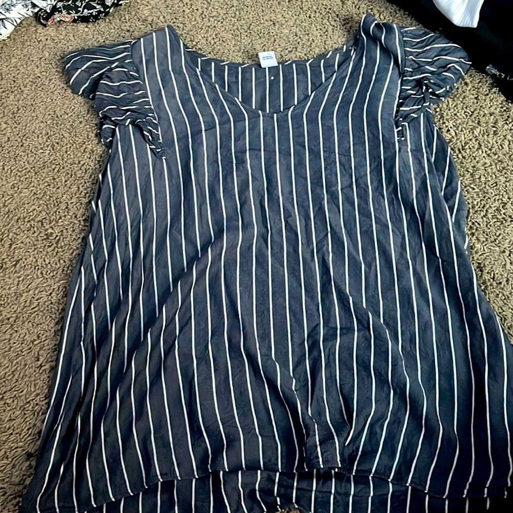 Blue and white short sleeve shirt with ruffle sleeves.